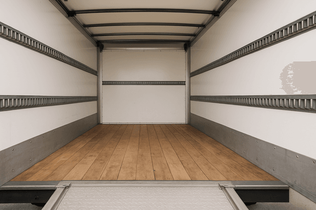 Empty moving truck cargo area with tie-down points